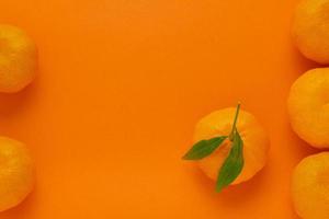 Mandarin on orange background for idea minimalism photo