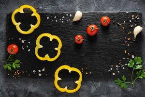 Colorful vegetables composition with yellow pepper, tomatoes, greens. Top view. photo