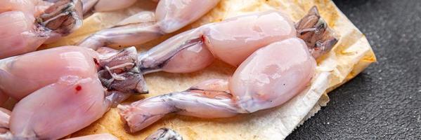 frog legs raw meat fresh meal food snack on the table copy space food background rustic top view photo