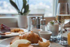 Wine and food served in plate at restaurant in luxury hotel photo