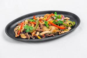 Chicken mushroom and capsicum stir fry recipe served on a sizzling plate. Chicken Fajita Recipe, Asian recipes. photo