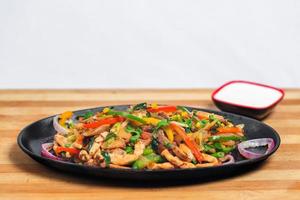 Chicken mushroom and capsicum stir fry recipe served on a sizzling plate. Chicken Fajita Recipe, Asian recipes. photo