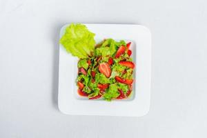 Colorful delicious Strawberry lettuce Salad with Strawberry Balsamic Dressing. Top View and Closeup views. photo