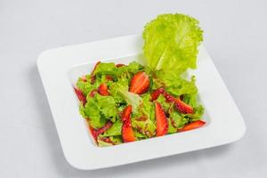 Colorful delicious Strawberry lettuce Salad with Strawberry Balsamic Dressing. Top View and Closeup views. photo