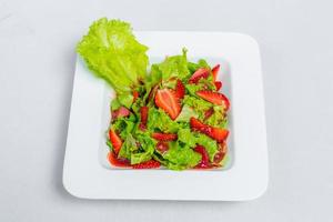 Colorful delicious Strawberry lettuce Salad with Strawberry Balsamic Dressing. Top View and Closeup views. photo