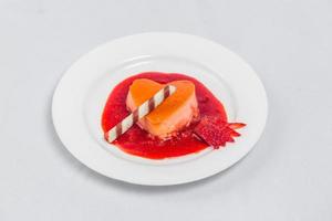 Heart shaped pudding with strawberry sauce and wafer. Valentines dessert recipe. photo