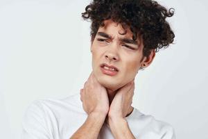 guy in white t-shirt and joint pain health problems studio photo