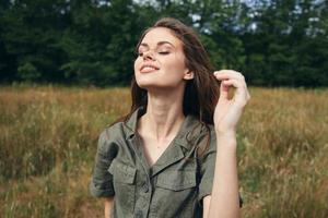 Woman with closed eyes and nature fresh air photo