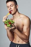 muscular torso man plate of salad meal energy vitamins photo