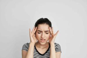 brunette holding his head migraine depression isolated background photo