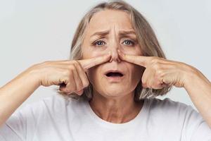 elderly woman runny nose handkerchief cold photo