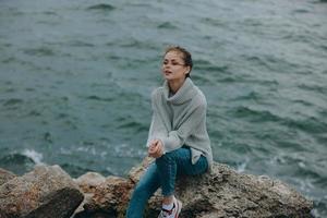 portrait of a woman nature rocks coast landscape Ocean Relaxation concept photo