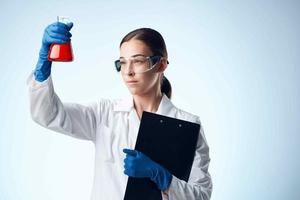 woman laboratory assistant medicine research biology technology analyzes photo