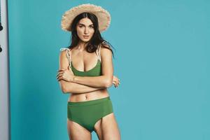 woman in green swimsuit beach season summer glamor photo