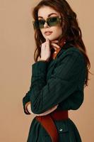 attractive woman wearing sunglasses posing fashion lifestyle beige background photo