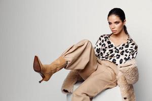 pretty woman in trendy autumn clothes leopard shirt studio photo