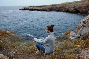 woman beach tourism cloudy weather stone coast Relaxation concept photo