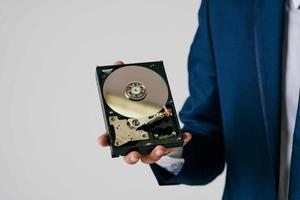 man holding a hard drive information protection technology photo