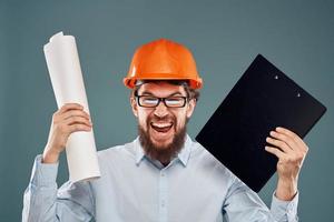 Cropped view of cheerful bearded man in orange paint in glasses with documents in hands photo