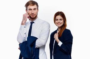 man and woman in suits are standing next to work colleagues finance office light background photo