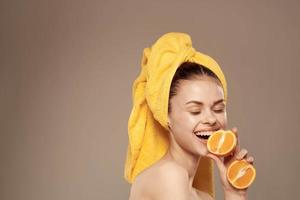 cheerful woman with oranges in her hands clean skin spa treatments photo