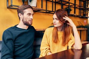 Lovers man and woman at a table in a cafe communication friends family photo