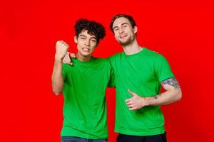 Cheerful friends green t-shirts emotions communication hug friendship photo