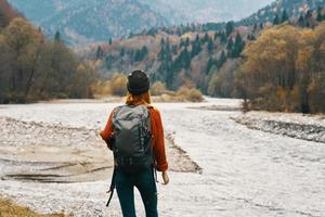 woman wearing a hat backpack landscape mountains model gesturing with hands photo