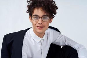 guy curly hair glasses and jacket photography studio model light background Copy Space photo