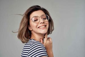 pretty woman in a striped T-shirt posing Studio photo