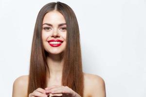 Brunette with bare shoulders charming smiles red lips photo