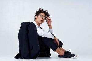 curly haired man in classic suit model studio photography sneakers photo