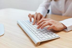 Closeup shot hands of businesswoman journalist office worker freelancer typing report doing documents on keyboard. Online communication, Remote job or Education. Copy space, wide angle photo