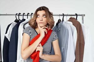 beautiful woman clothes hanger shopping light background photo