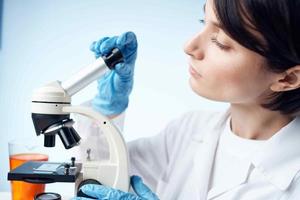 woman laboratory assistant microscope research technology science photo