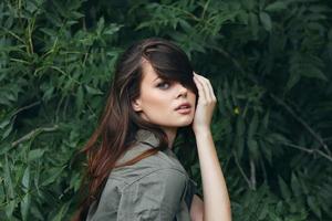 Portrait of a woman Touching the hair on his head in the forest travel photo