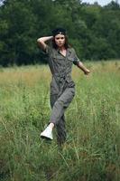 woman outdoors in green jumpsuit travel tall grass summer photo