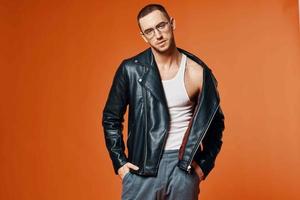 man in leather jacket posing fashion orange background model photo