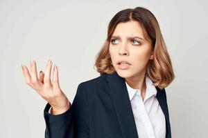 Business woman in suit gesturing with hands emotions work manager close-up photo
