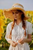 beautiful sweet girl looking in the sunflower field Summer time photo