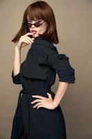 Fashionable woman Black coat and passionate look dark glasses photo