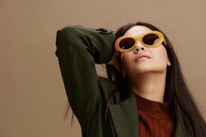 pretty woman in a stylish suit in black glasses posing isolated background photo