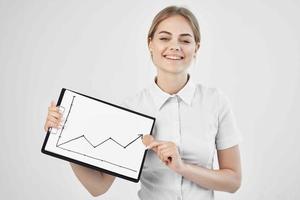 Businesswoman in a white shirt with a folder in hand light background photo