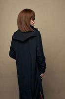 Beautiful model classic coat good mood laughing studio photo