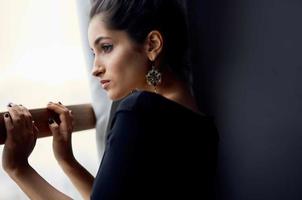 beautiful woman near window posing attractive look earrings lifestyle studio photo