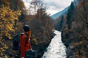woman hiker with backpack in the mountains autumn forest photo