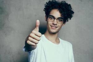 guy in white t-shirt gesturing with hand curly hair emotions Studio photo