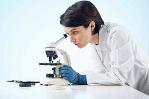 woman in laboratory microscope science research analysis photo