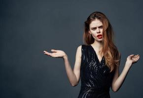 Portrait of a beautiful woman gesturing with her hands gray background cropped view close-up photo