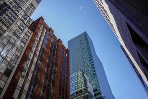 new york manhattan skyscrapers view from the street to the top of the building on sunny clear day photo